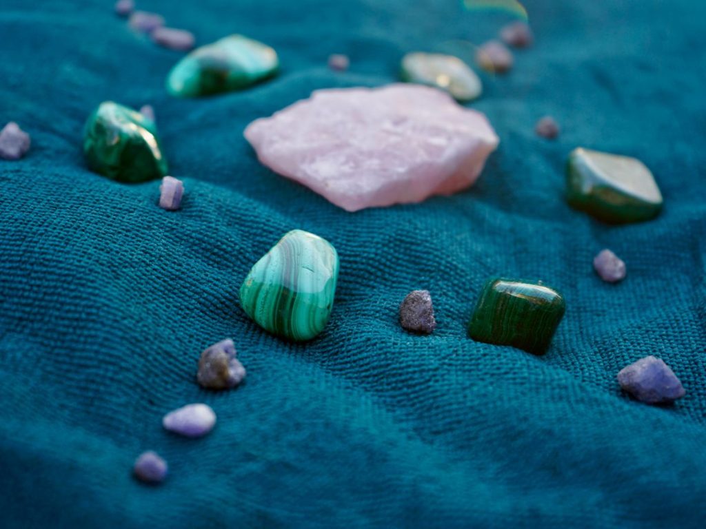 rose quartz with another crystals on blue cloth